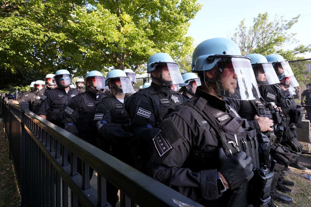 Some protesters tear down security fence as thousands march outside Democratic National Convention