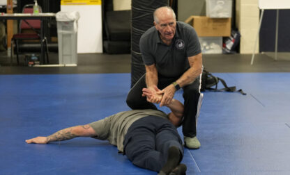 Instructor Dave Rose demonstrates a prone handcuffing position on a student during an Arrest & Control Instructor course in Sacramento, Calif., on Thursday, Jan. 18, 2024. Rose has trained generations of officers that prone restraint is safe. His pupils are instructors who take his training back to their departments. (AP Photo/Rich Pedroncelli)