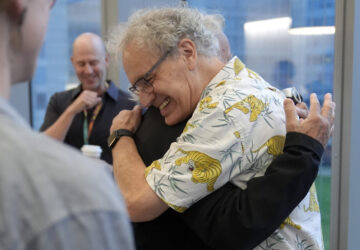 Victor Ambros, 2024 Nobel Prize winner in physiology or medicine, and professor of natural science at the University of Massachusetts Medical School, right, hugs collegue Allan Jacobson, at the school, in Worcester, Mass. Monday, Oct. 7, 2024. (AP Photo/Steven Senne)