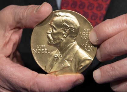 FILE - A close-up view of a Nobel Prize medal at the National Institutes of Health (NIH) in Bethesda, Md., Tuesday, Dec. 8, 2020. (AP Photo/Jacquelyn Martin, File)