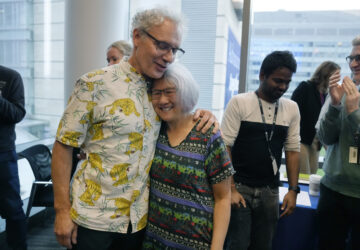 Victor Ambros, left, 2024 Nobel Prize winner in physiology or medicine, and professor of natural science at the University of Massachusetts Medical School, hugs his wife Rosalind Lee following a news conference, Monday, Oct. 7, 2024, at the school in Worcester, Mass. (AP Photo/Steven Senne)