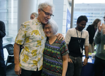 Victor Ambros, left, 2024 Nobel Prize winner in physiology or medicine, and professor of natural science at the University of Massachusetts Medical School, hugs his wife Rosalind Lee following a news conference, Monday, Oct. 7, 2024, at the school in Worcester, Mass. (AP Photo/Steven Senne)