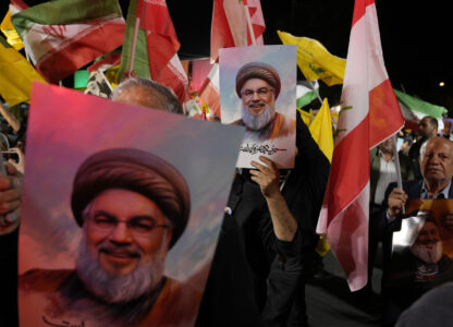 Iranian demonstrators hold posters of slain Hezbollah leader Hassan Nasrallah during an anti-Israeli protest at Felestin (Palestine) Square in Tehran, Iran, Tuesday, Oct. 1, 2024. (AP Photo/Vahid Salemi)