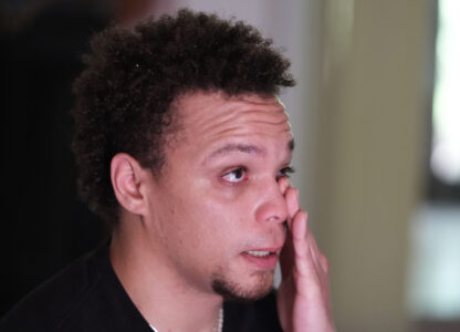 Lij Hacker wipes away a tear while talking about his late brother, Asson Hacker, during an interview in Bloomington, Ind., on June 4, 2024. (AP Photo/Darron Cummings)