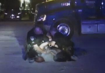 In this image from video provided by the Evansville Police Department, Edward Snukis, bottom center, is restrained by officers in Evansville, Ind., on Sept. 13, 2019. Snukis, 55, died after police officers shocked him with a Taser, punched him and held him face down. (Evansville Police Department via AP)