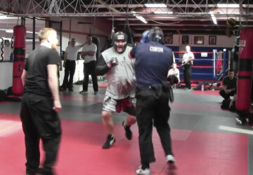 In this image from video made by the Evansville Police Department, police recruit Tanner Corum, foreground right, undergoes training with Mike Fisher, a sheriff's major from a nearby county, during 