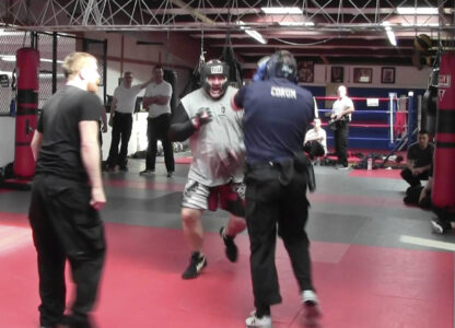 In this image from video made by the Evansville Police Department, police recruit Tanner Corum, foreground right, undergoes training with Mike Fisher, a sheriff's major from a nearby county, during 