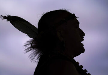 FILE - Tatanka Gibson of the Haliwa-Saponi/Nansemond Tribal Nations leads attendees in song and dance during a gathering marking Indigenous Peoples Day at Penn Treaty Park, Oct. 11, 2021, in Philadelphia. (AP Photo/Matt Rourke, File)