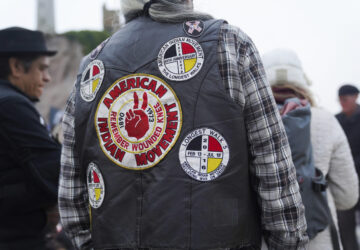 A man wears a vest in support of the American Indian Movement on Indigenous Peoples Day Monday, Oct. 14, 2024, in San Francisco. (AP Photo/Minh Connors)