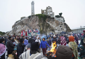 People attending the Indigenous Peoples Day Sunrise Gathering offer tobacco to the fire on Monday, Oct. 14, 2024, in San Francisco. (AP Photo/Minh Connors)