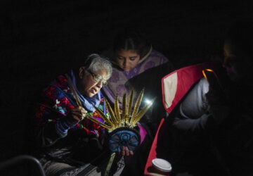 Teacher Irma Pineda teaches Amayah Lara-Ponce in putting together a capilli on Indigenous Peoples Day Monday, Oct. 14, 2024, in San Francisco. (AP Photo/Minh Connors)