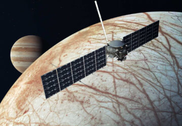 This illustration provided by NASA depicts the Europa Clipper spacecraft over the moon, Europa, with Jupiter at background left. (NASA/JPL-Caltech via AP)