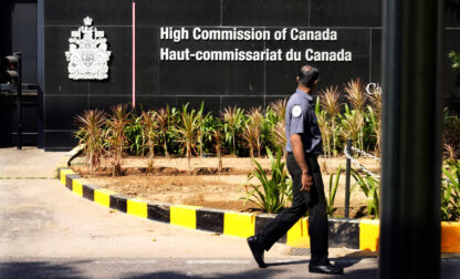 A private security man walks outside the Canadian high commission in New Delhi, India, Tuesday, Oct. 15, 2024 after India and Canada expelled each other’s top diplomats over an ongoing dispute about the killing of a Sikh activist in Canada. (AP Photo/Manish Swarup)