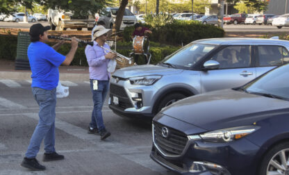 Musicians play for tips from motorists in Culiacan, Sinaloa state, Mexico, Monday, Oct. 14, 2024. (AP Photo)