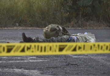 Caution tape surrounds a body lying on the street Culiacan, Sinaloa state, Mexico, Monday, Oct. 14, 2024. (AP Photo)