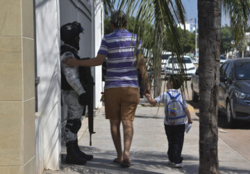 A resident pats a National Guard on the arm after picking a child up from school in Culiacan, Sinaloa state, Mexico, Monday, Oct. 14, 2024. (AP Photo)