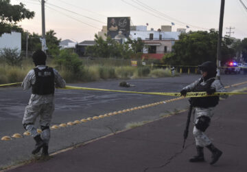 National Guards cordon off an area where a corpse lies on a street in Culiacan, Sinaloa state, Mexico, Monday, Oct. 14, 2024. (AP Photo)