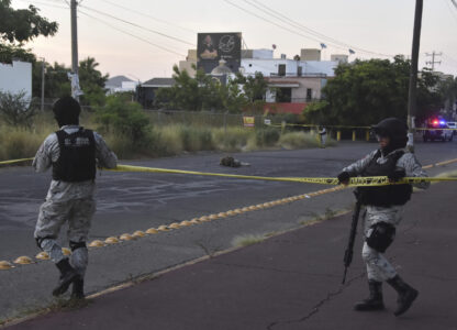 National Guards cordon off an area where a corpse lies on a street in Culiacan, Sinaloa state, Mexico, Monday, Oct. 14, 2024. (AP Photo)