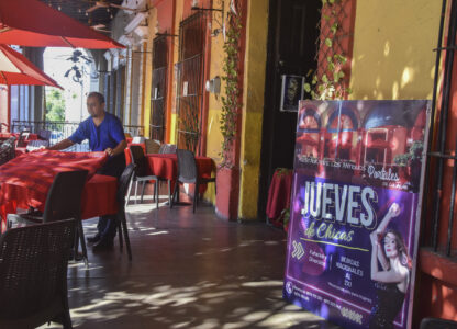 A waiter arranges a table outside the restaurant The Old Portales of Culiacan where a sign advertises two-for-one prices on drinks for women on Thursdays, in Culiacan, Sinaloa state, Mexico, Monday, Oct. 14, 2024. (AP Photo)