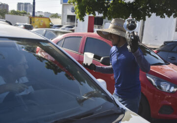 A musician collects tips from motorists in Culiacan, Sinaloa state, Mexico, Monday, Oct. 14, 2024. (AP Photo)