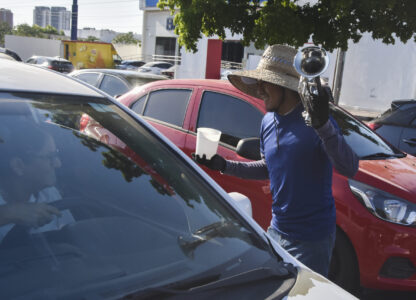 A musician collects tips from motorists in Culiacan, Sinaloa state, Mexico, Monday, Oct. 14, 2024. (AP Photo)