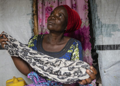 Nelly Shukuru, 51, hold the scarf she had planned on using to hang herself after spending three years displaced in the Lushagala camp in Goma, Democratic Republic of the Congo, Tuesday, Aug. 27, 2024. (AP Photo/Moses Sawasawa)