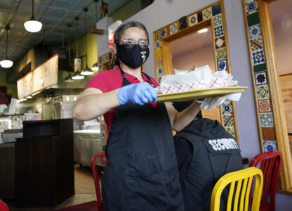 File - A waitress works at a restaurant in Chicago on March 23, 2023. (AP Photo/Nam Y. Huh, File)