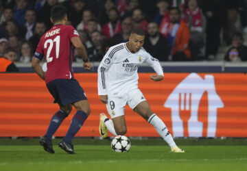 Real Madrid's Kylian Mbappe, right, dribbles the ball past Lille's Benjamin Andre during the Champions League opening phase soccer match between Lille and Real Madrid at the Stade Pierre Mauroy in Villeneuve-d'Ascq, outside Lille, France, Wednesday, Oct. 2, 2024. (AP Photo/Thibault Camus)