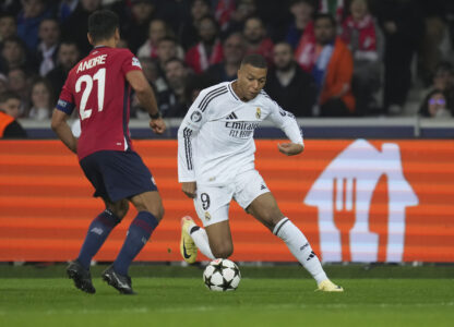 Real Madrid's Kylian Mbappe, right, dribbles the ball past Lille's Benjamin Andre during the Champions League opening phase soccer match between Lille and Real Madrid at the Stade Pierre Mauroy in Villeneuve-d'Ascq, outside Lille, France, Wednesday, Oct. 2, 2024. (AP Photo/Thibault Camus)