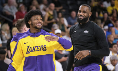 FILE - Los Angeles Lakers guard Bronny James, left, and forward LeBron James warm up before a preseason NBA basketball game against the Phoenix Suns, Sunday, Oct. 6, 2024, in Palm Desert, Calif. (AP Photo/William Liang, File)