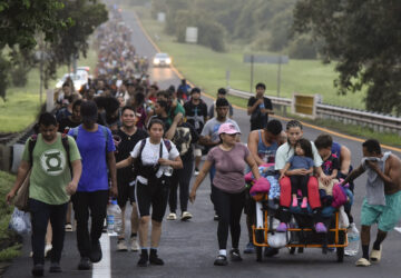 Migrants walk along the Huixtla highway in the state of Chiapas, Mexico, Tuesday, Oct. 22, 2024, hoping to reach the country's northern border and ultimately the United States. (AP Photo/Edgar H. Clemente)