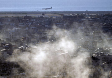 A Middle East Airlines airplane comes in for a landing at Beirut International Airport as smoke rises from Israeli airstrikes in Dahiyeh, in the southern suburb of Beirut, Lebanon, Thursday, Oct. 24, 2024. (AP Photo/Bilal Hussein)