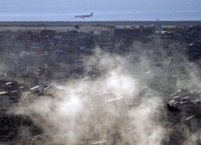 A Middle East Airlines airplane comes in for a landing at Beirut International Airport as smoke rises from Israeli airstrikes in Dahiyeh, in the southern suburb of Beirut, Lebanon, Thursday, Oct. 24, 2024. (AP Photo/Bilal Hussein)