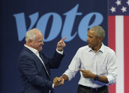 Democratic vice presidential nominee Minnesota Gov. Tim Walz, left, and former President Barack Obama shake hands at a campaign event Tuesday, Oct. 22, 2024, in Madison, Wis. (AP Photo/Morry Gash)