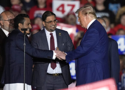 Republican presidential nominee former President Donald Trump, right, greet local Muslim leaders during a campaign rally at the Suburban Collection Showplace, Saturday, Oct. 26, 2024 in Novi, Mich. (AP Photo/Carlos Osorio)