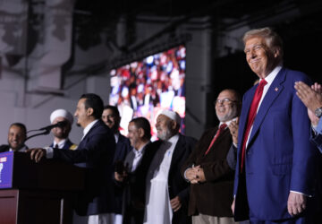 Republican presidential nominee former President Donald Trump, right, looks on as local Muslim leaders speak during a campaign rally at the Suburban Collection Showplace, Saturday, Oct. 26, 2024, in Novi, Mich. (AP Photo/Alex Brandon)