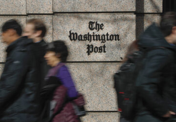 FILE - People walk by the One Franklin Square Building, home of The Washington Post newspaper, in downtown Washington, Feb. 21, 2019. (AP Photo/Pablo Martinez Monsivais, File)