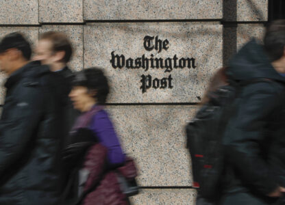 FILE - People walk by the One Franklin Square Building, home of The Washington Post newspaper, in downtown Washington, Feb. 21, 2019. (AP Photo/Pablo Martinez Monsivais, File)