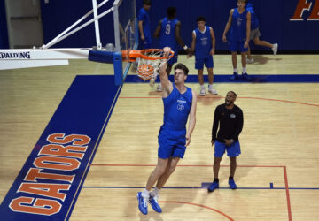 Olivier Rioux, 7-foot-4 NCAA college basketball player from Florida, dunks the ball while practicing with the team, Friday, Oct. 18, 2024, in Gainesville, Florida. (AP Photo/John Raoux)