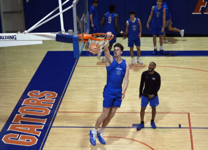 Olivier Rioux, 7-foot-4 NCAA college basketball player from Florida, dunks the ball while practicing with the team, Friday, Oct. 18, 2024, in Gainesville, Florida. (AP Photo/John Raoux)