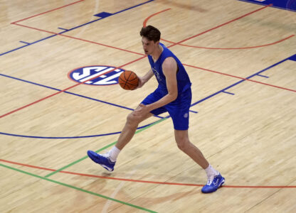 Olivier Rioux, 7-foot-4 NCAA college basketball player from Florida, moves the ball downcourt during the team's practice, Friday, Oct. 18, 2024, in Gainesville, Florida. (AP Photo/John Raoux)