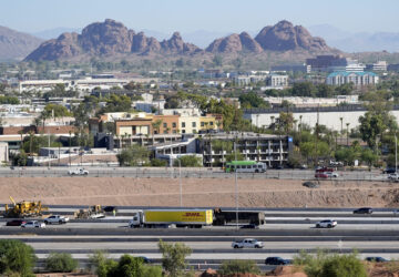 Interstate 10 slices through an area of mixed use businesses and hotels Tuesday, Sept. 24, 2024, in Tempe, Ariz. (AP Photo/Ross D. Franklin)