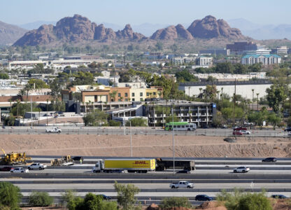 Interstate 10 slices through an area of mixed use businesses and hotels Tuesday, Sept. 24, 2024, in Tempe, Ariz. (AP Photo/Ross D. Franklin)