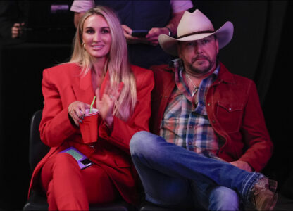 Brittany and Jason Aldean listen as Republican presidential nominee former President Donald Trump speaks at a Turning Point Action campaign rally, Wednesday, Oct. 23, 2024, in Duluth, Ga. (AP Photo/Alex Brandon)