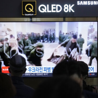 FILE - A TV screen shows an image of soldiers believed to be from North Korea stand in line to receive supplies from Russia during a news program at Seoul Railway Station in Seoul, South Korea, on Oct. 21, 2024. (AP Photo/Ahn Young-joon, File)