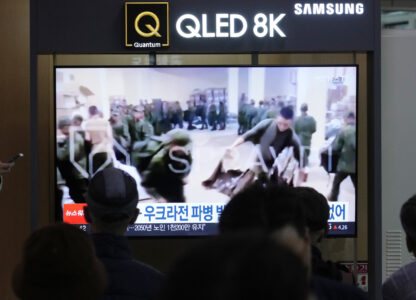 FILE - A TV screen shows an image of soldiers believed to be from North Korea stand in line to receive supplies from Russia during a news program at Seoul Railway Station in Seoul, South Korea, on Oct. 21, 2024. (AP Photo/Ahn Young-joon, File)