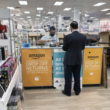 FILE - People return items purchased online at an Amazon counter inside a Kohl's department store in Clifton, New Jersey, on September 3, 2021. (AP Photo/Ted Shaffrey, File)