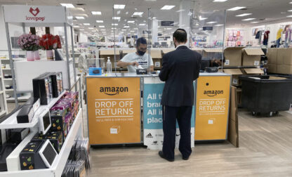 FILE - People return items purchased online at an Amazon counter inside a Kohl's department store in Clifton, New Jersey, on September 3, 2021. (AP Photo/Ted Shaffrey, File)