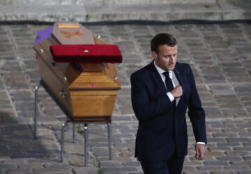 FILE - French President Emmanuel Macron leaves after paying his respects by the coffin of slain teacher Samuel Paty in the courtyard of the Sorbonne university during a national memorial event, Wednesday, Oct. 21, 2020 in Paris. (AP Photo/Francois Mori, Pool, File)