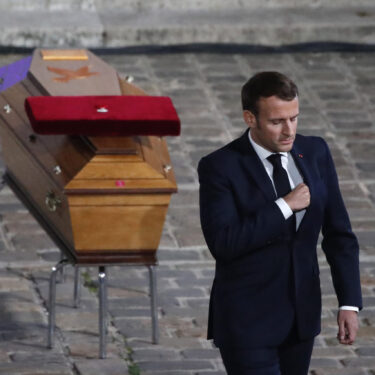 FILE - French President Emmanuel Macron leaves after paying his respects by the coffin of slain teacher Samuel Paty in the courtyard of the Sorbonne university during a national memorial event, Wednesday, Oct. 21, 2020 in Paris. (AP Photo/Francois Mori, Pool, File)